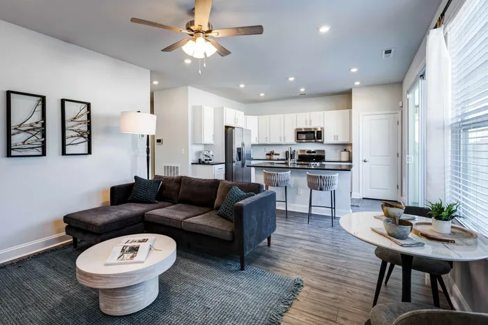 Living room area with open living floor plan overlooking kitchen