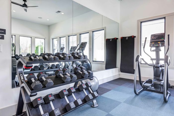 Fitness center with mirrors and dumbbell station