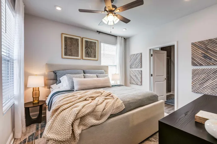 large bedroom with high ceilings, ceiling fans, and enough space to accommodate a king size bed