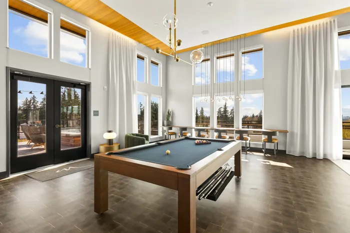 billiards table with large room and windows at modera overlake apartment homes for rent in wa