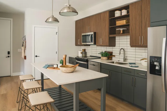 kitchen area with chefs island, quartz countertops and custom backsplash