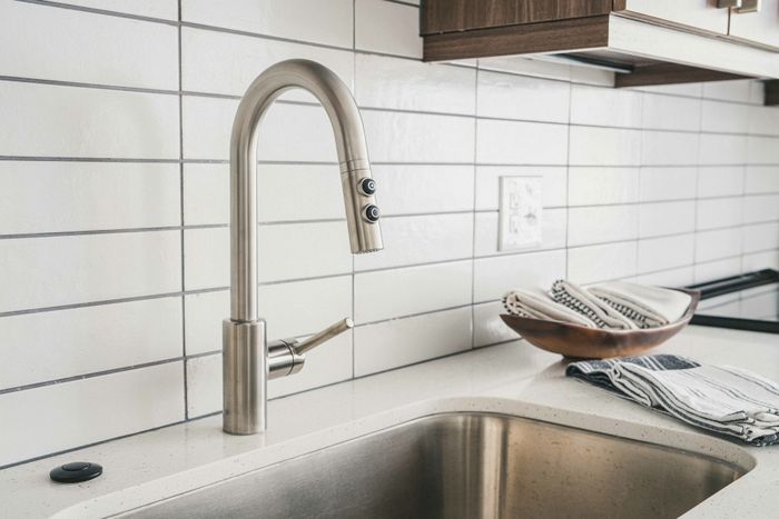 close up of stainless steel faucet and large sink basin