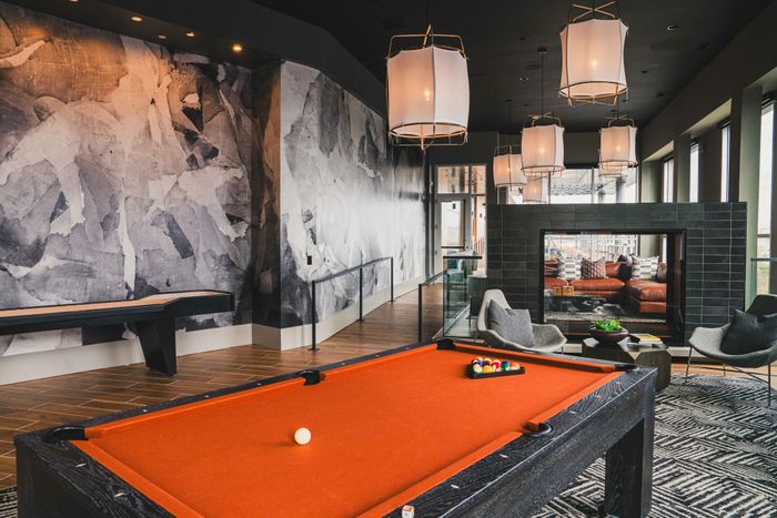 orange pool table in clubhouse area