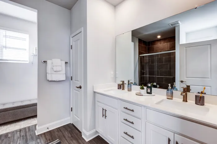 Bathroom with quartz countertops and white cabinetry