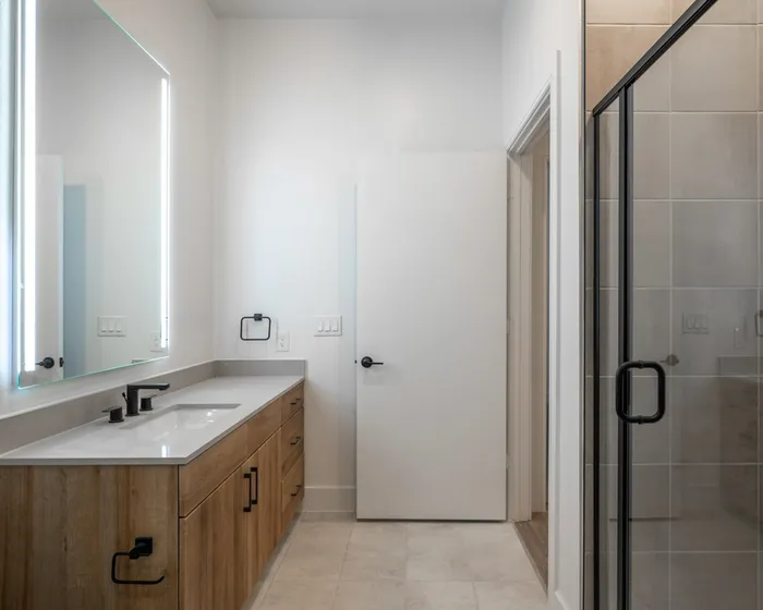 Large bathroom with modern vanity and natural lighting