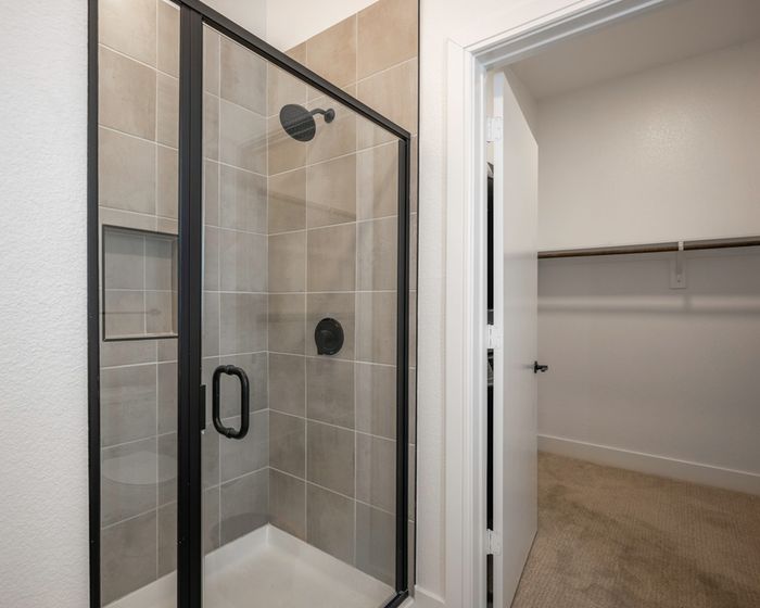 Spacious standing shower with designer black hardware