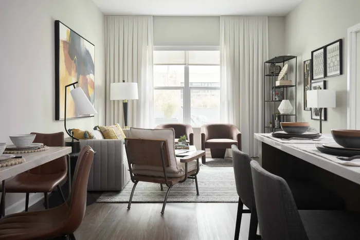 spacious living room with comfortable seating and large windows for plenty of natural light