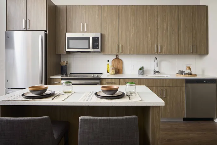 custom cabinetry, quartz countertops, and chef's island create a stunning kitchen space