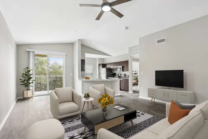 living room looking onto glass sliding door with balcony alister sunset valley apartment homes for rent in austin tx