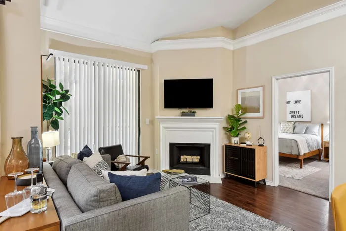 furnished living room looking onto bedroom with bed alister sunset valley apartment homes for rent in austin tx
