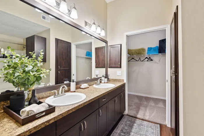 double vanity bathroom with light fixtures alister sunset valley apartment homes for rent in austin tx
