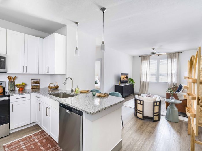 Open floor plan with spacious kitchen overlooking open living room