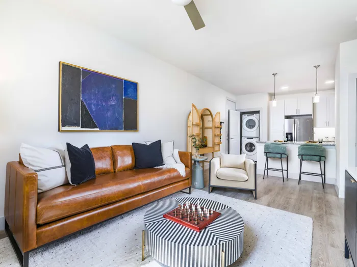 Living area equipped with ceiling fan, wood-style flooring, and more