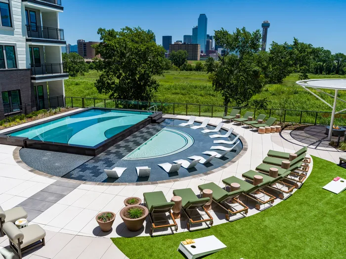 resort style pool with lounging chairs and cabana