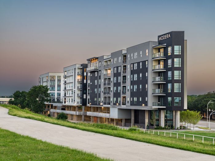 exterior of modern trinity apartments at dusk