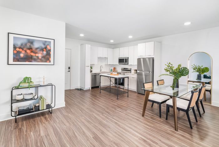 spacious kitchen with white cabinetry, stainless steel appliances, and eat-in islands
