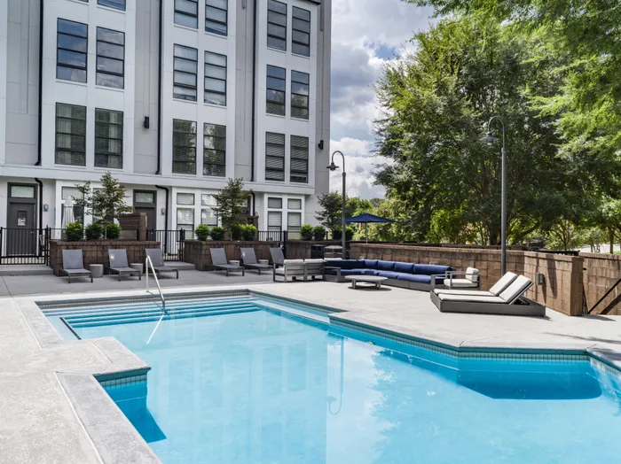 pool with lounge seating on sunny day alister uptown apartment homes for rent in charlotte nc