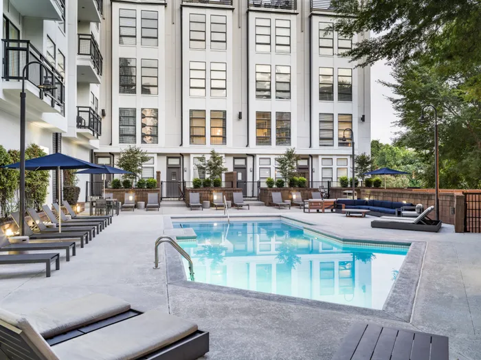 pool and sundeck next to apartment building alister uptown apartment homes for rent in charlotte nc