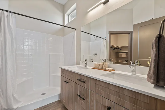 Large shower and double vanity inside the primary bathroom at Modern Craftsman Black Cat