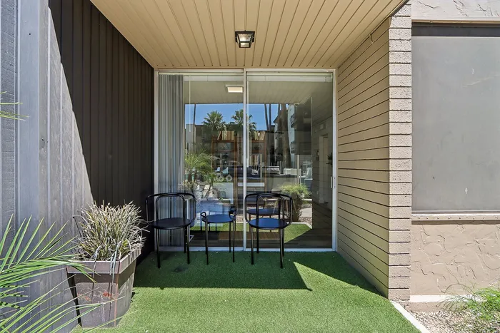 Charming outdoor patio with cozy seating and greenery, perfect for relaxation and enjoying the view.