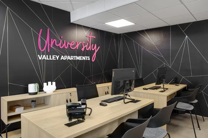 Modern University Valley Apartments office with sleek decor, stylish desks, and welcoming ambiance.