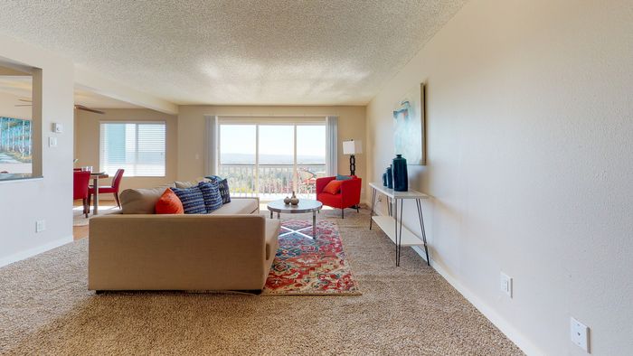 Renton WA Apartments for Rent - Sunset View Spacious Living Room with Floor to Ceiling Sliding Glass Door Leading to the Balcony