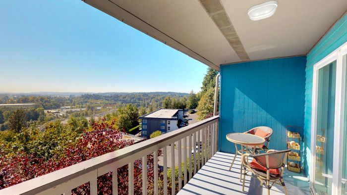 Renton WA Apartments for Rent - Sunset View - Apartment Balcony with Blue Walls and Views of Foliage