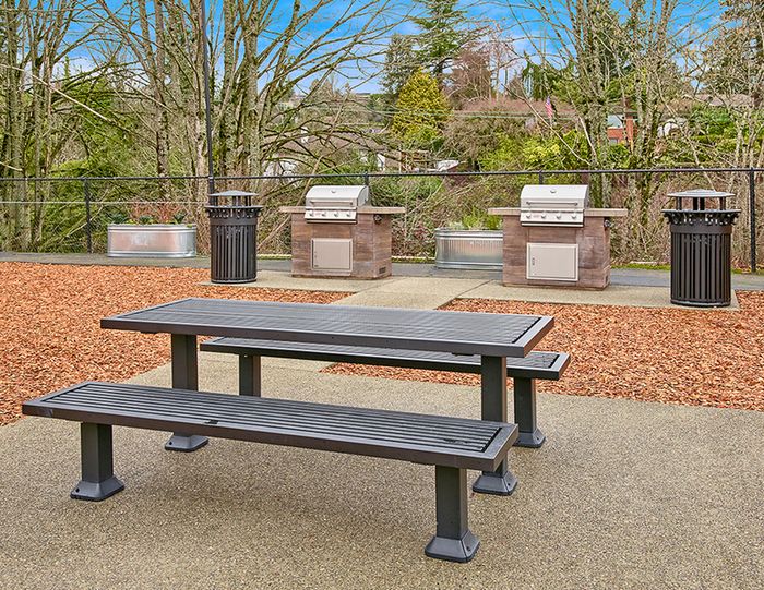 Renton Apartments for Rent - Sunset View - Picnic Table with Two Grills and Wood Chips