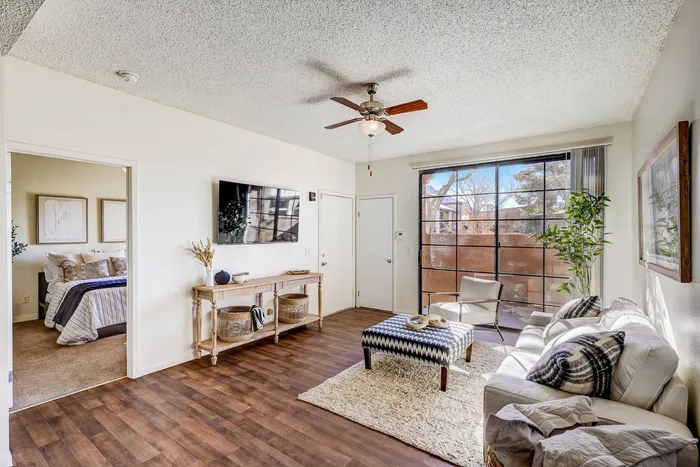 Apartments for Rent in North Las Vegas, NV - Desert Ridge - Cozy Living Room with Wood Plank Flooring, Ceiling Fan, and Furniture