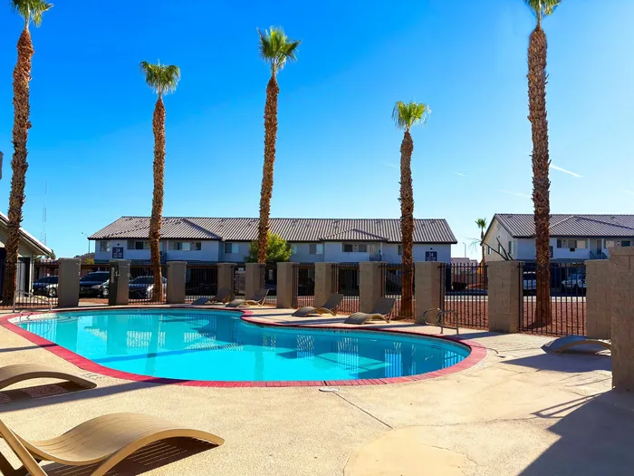 North Las Vegas, NV, Apartments for Rent - Portola Del Sol - Pool with Lounge Chairs and Palm Trees