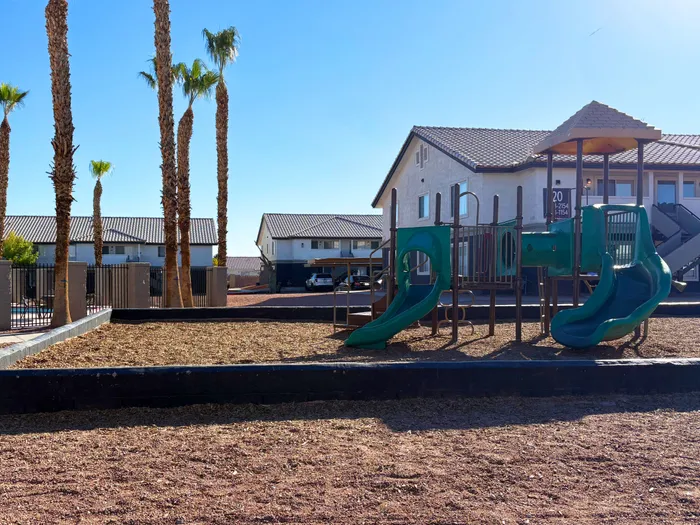 Apartments for Rent in North Las Vegas, NV - Portola Del Sol - Playground Area with Wood Chips, Slides, and Landscaping