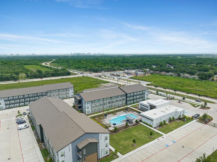Exterior ariel view showing community clubhouse and apartment buildings