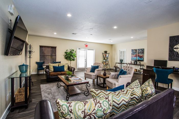 Inviting living space with plush seating, elegant decor, and natural lighting.