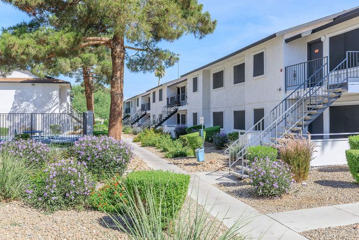 Beautifully landscaped garden apartments with lush greenery and vibrant flowers.