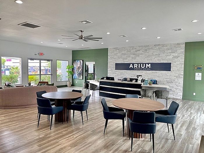 Inviting apartment lobby with modern seating, natural light, and stylish decor at ARIUM community.