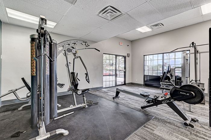 Modern fitness center equipped with state-of-the-art exercise machines and ample natural light, perfect for residents seeking an active lifestyle.