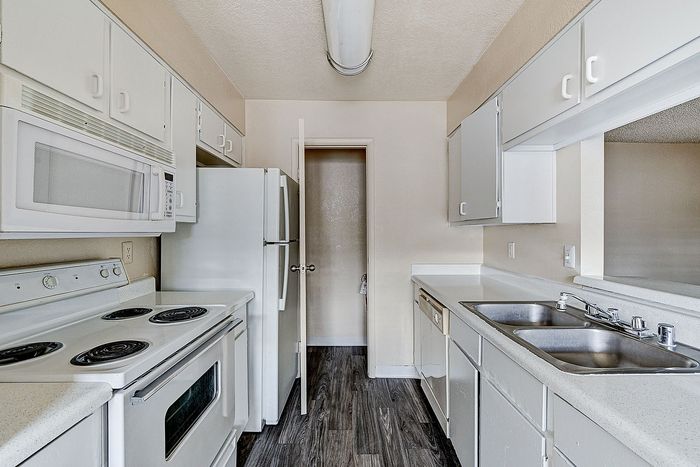 Bright and inviting kitchen featuring modern appliances, ample cabinetry, and sleek countertops.