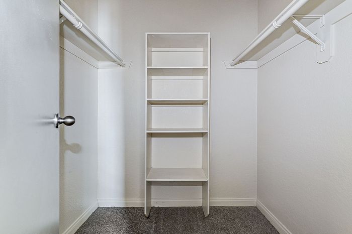 Spacious walk-in closet featuring ample shelving and hanging space for optimal organization.