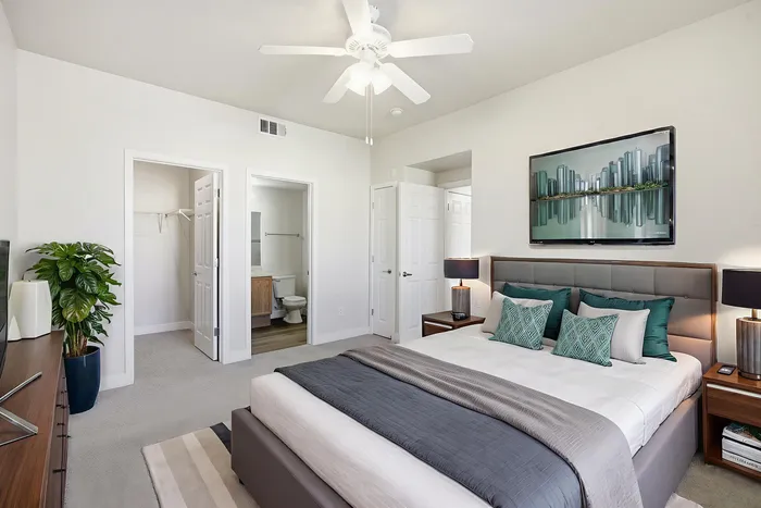 Bright and inviting bedroom with modern decor, featuring a comfortable bed, stylish artwork, and ensuite bathroom.