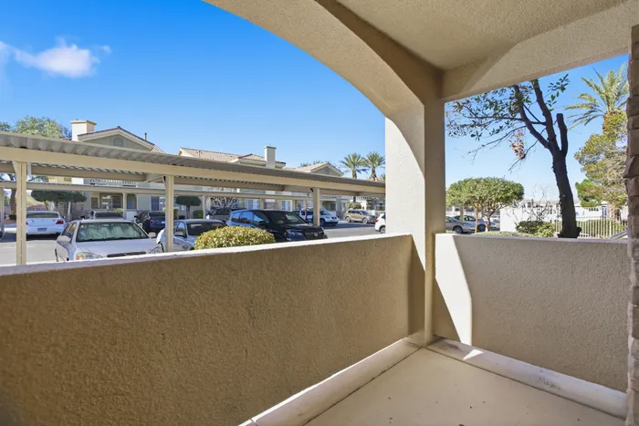 Inviting apartment balcony with serene neighborhood views and lush greenery, perfect for relaxation.