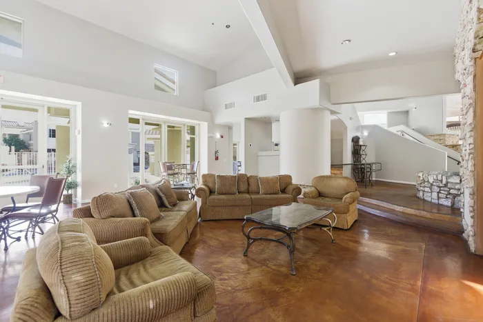 Spacious and inviting living area with plush seating and abundant natural light, featuring a modern open-concept design and chic decor.