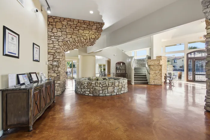 Luxurious lobby with elegant stone accents, warm hardwood floors, and inviting natural light creating a welcoming ambiance.