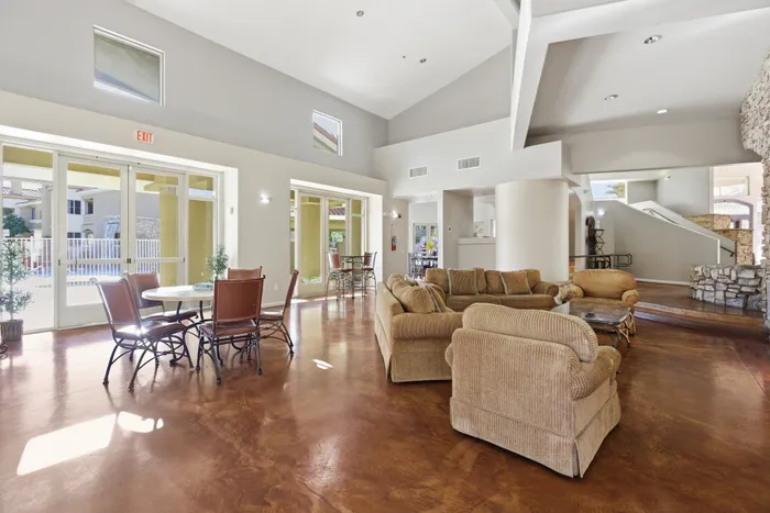 Spacious and inviting lounge area with elegant seating, large windows, and cozy lighting, perfect for social gatherings or relaxation.
