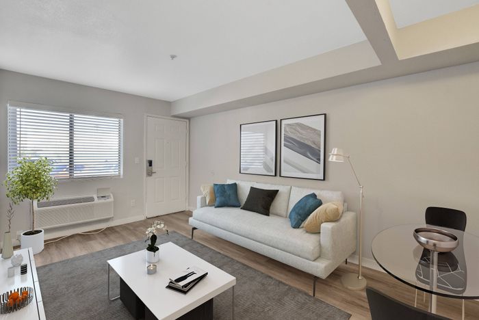 Bright and modern living room with sleek furniture, stylish decor, and abundant natural light.