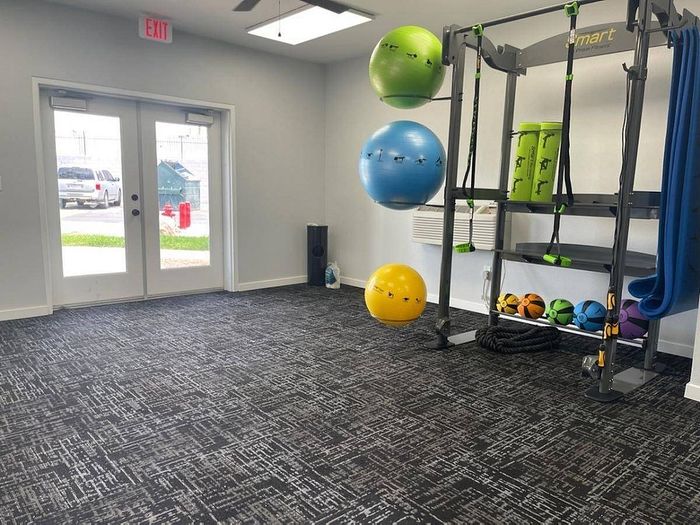 Modern fitness room with vibrant exercise balls and sleek gym equipment, perfect for a high-energy workout.
