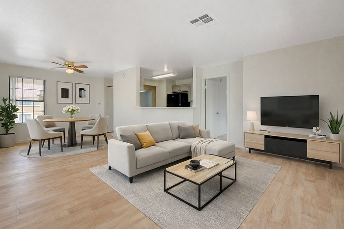 Bright, modern living room with elegant decor, featuring a cozy sofa, stylish dining area, and a sleek entertainment center.