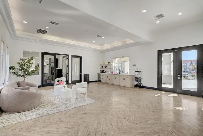 Elegant modern room with plush seating, stylish decor, and ample natural light.