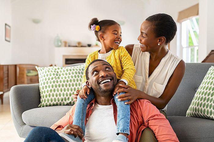 Happy family enjoying quality time together in a bright, modern living room with stylish decor and natural light.