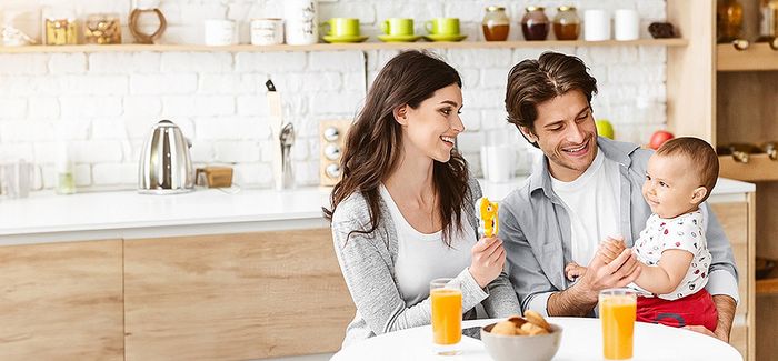 Bright and modern kitchen setting with a happy family enjoying a cheerful breakfast, enhancing the inviting space with warmth and vibrancy.