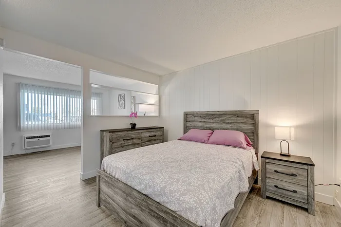 Inviting bedroom with rustic wooden furniture, soft lighting, and elegant decor, offering a cozy and stylish retreat.